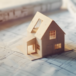 Maquette d'une maison posée sur des plans symbolisant l'hypothèque d'un bien pour financer un projet